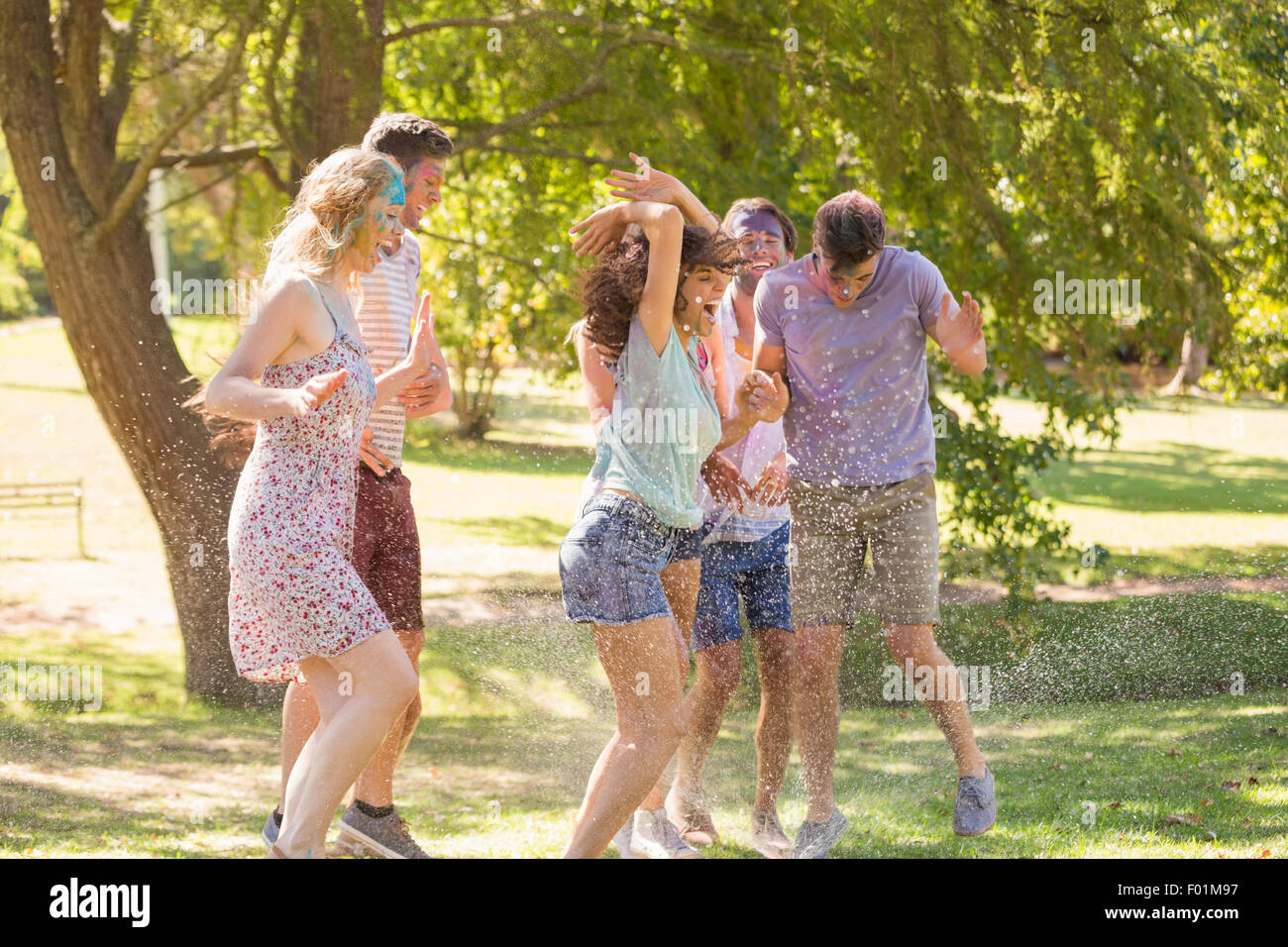 Giovani amici divertendosi con vernice a polvere Foto Stock