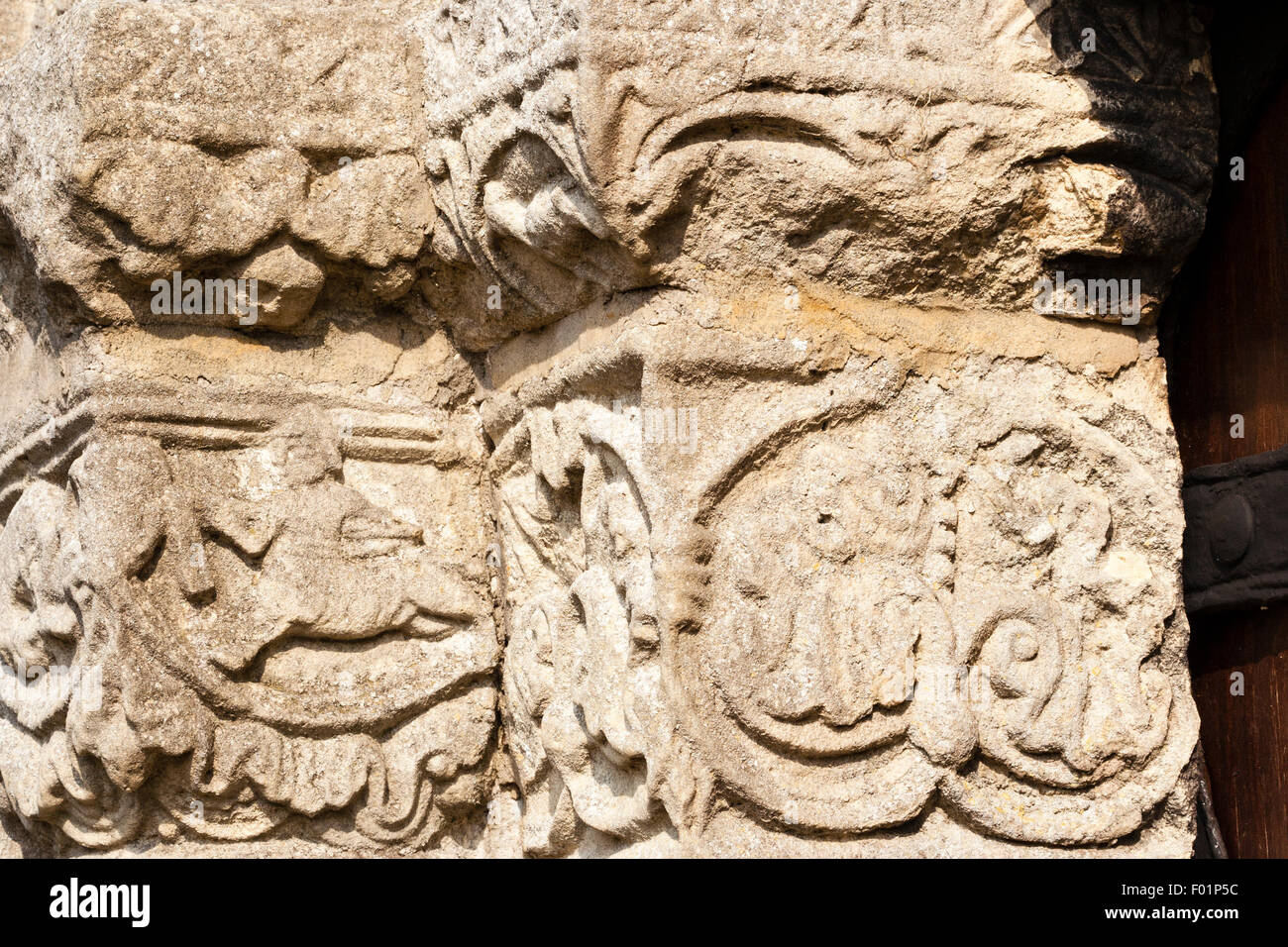 Inghilterra, Barfrestone. Norman sculture in pietra. Porta Sud, Onate incisioni su colonna porta comprendente un cavaliere normanno carica con lancia. Foto Stock