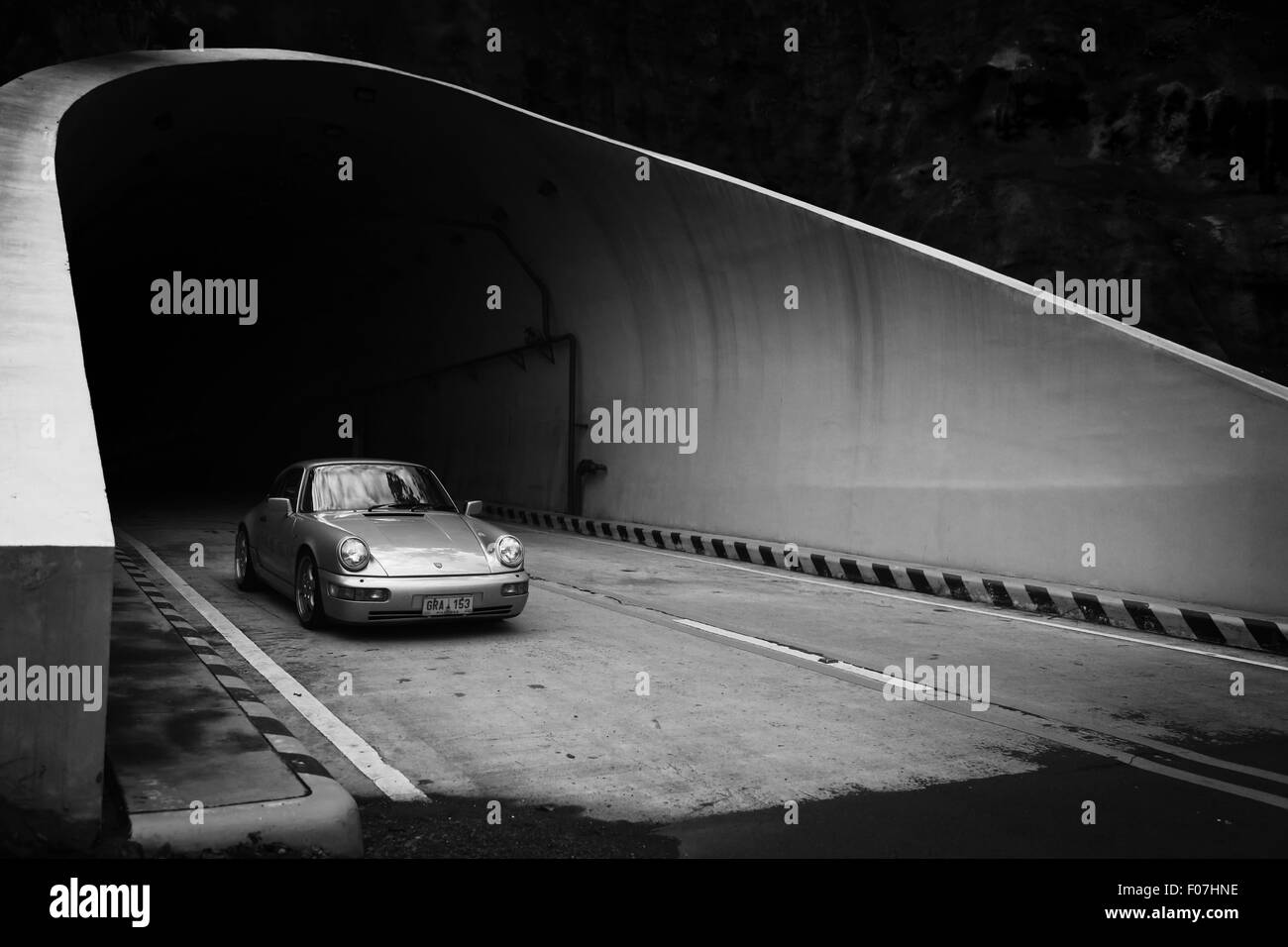 Uno degli ultimi raffreddato ad aria Porsche 911s, questo silver 1990 964 Carrera 2 esce Kaybiang tunnel. Foto Stock