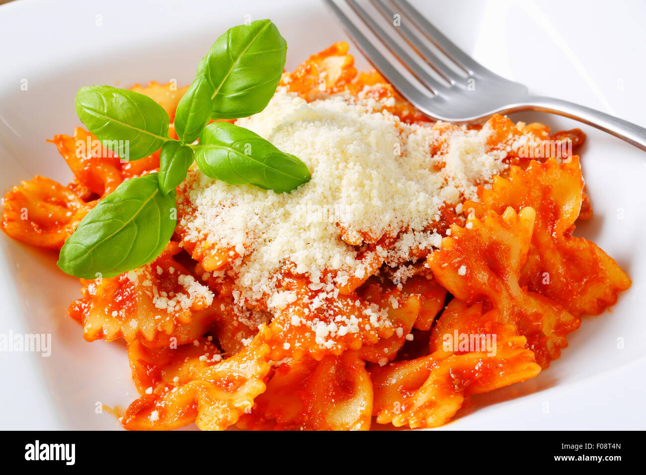 Filtro Bow tie pasta con salsa di pomodoro e scaglie di parmigiano Foto Stock