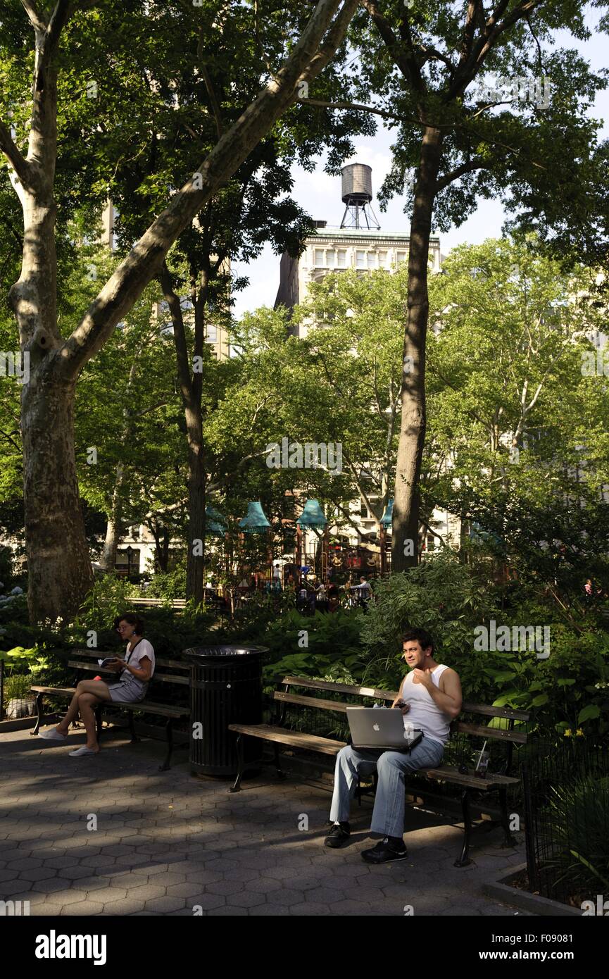 Persone rilassante in Madison Square Park si affaccia grattacieli di New York, Stati Uniti d'America Foto Stock