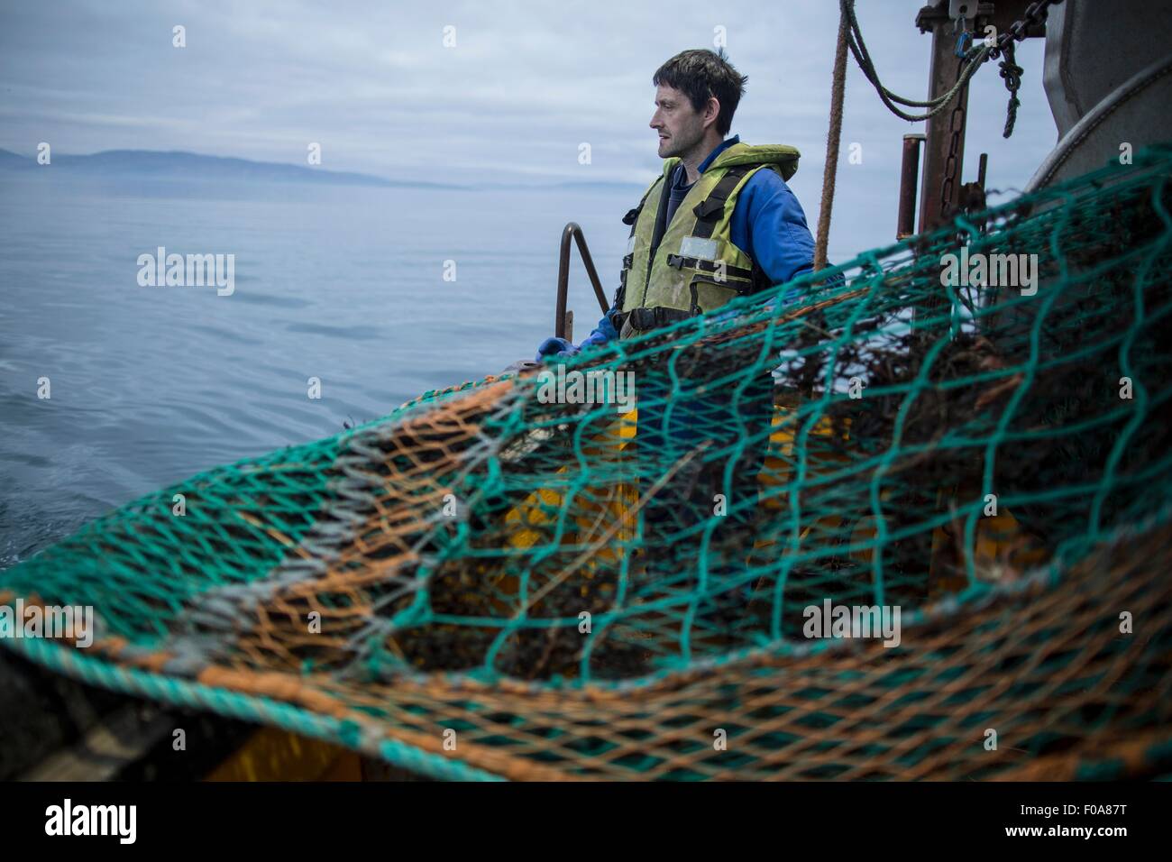 Fisherman preparazione net, Isola di Skye in Scozia Foto Stock