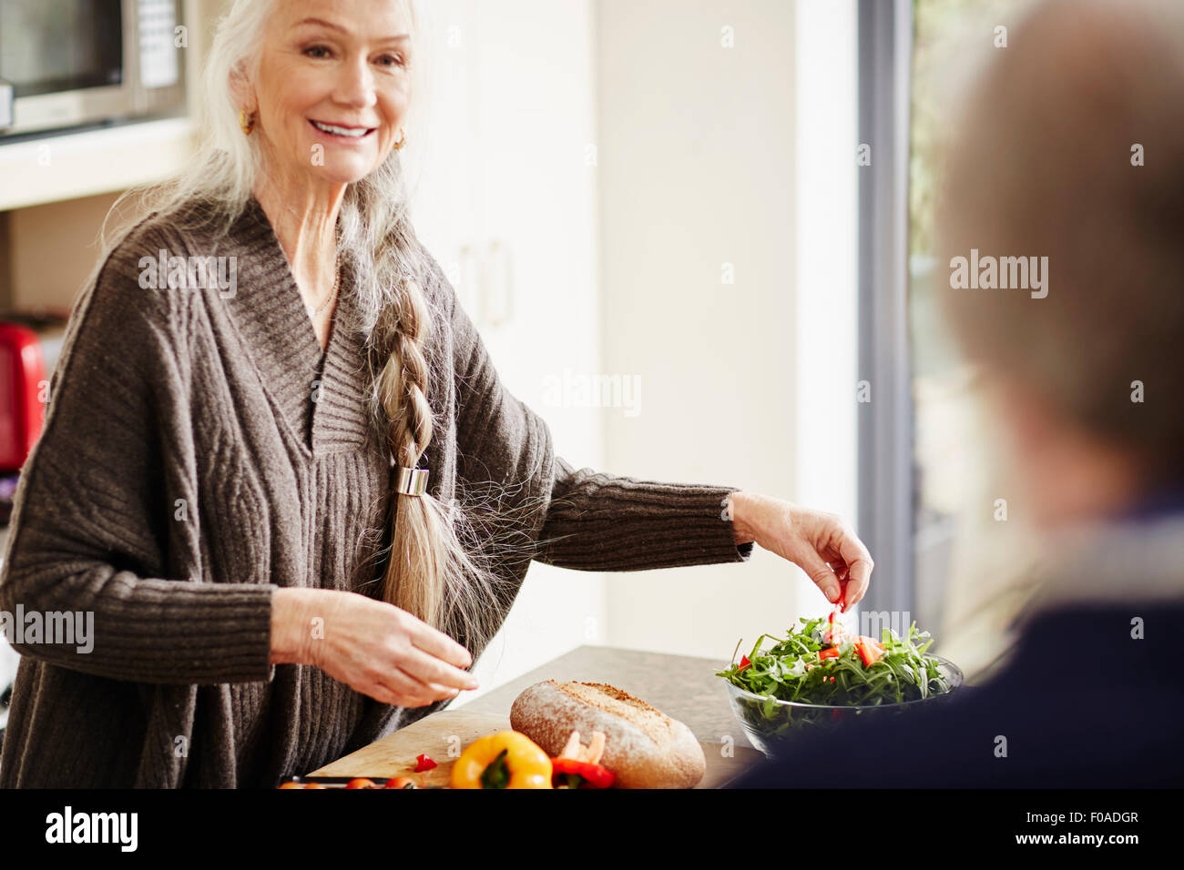 Donna senior di preparare il cibo in cucina Foto Stock