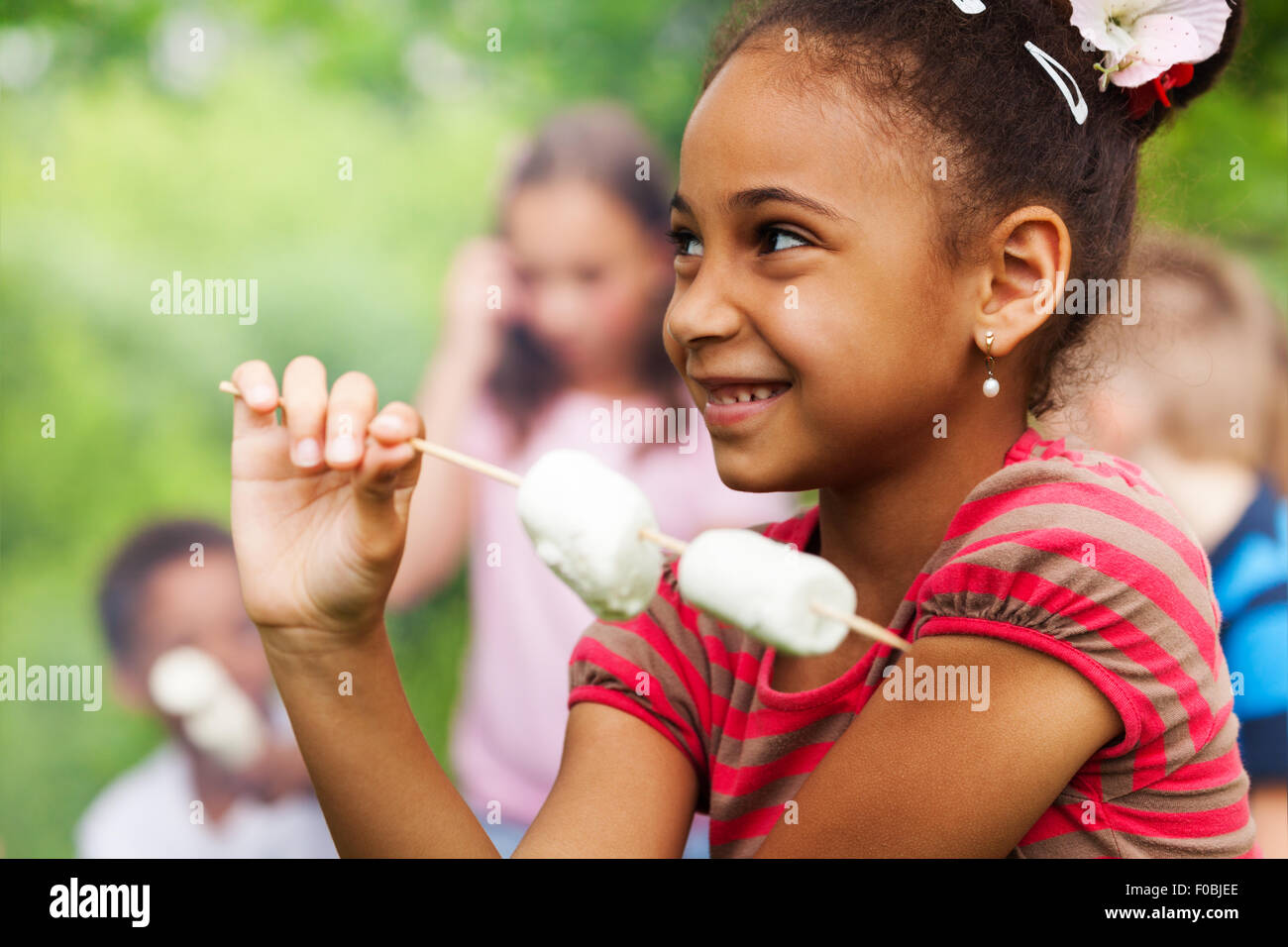 Ritratto di giovane ragazza africana e la bacchetta di marshmallow Foto Stock