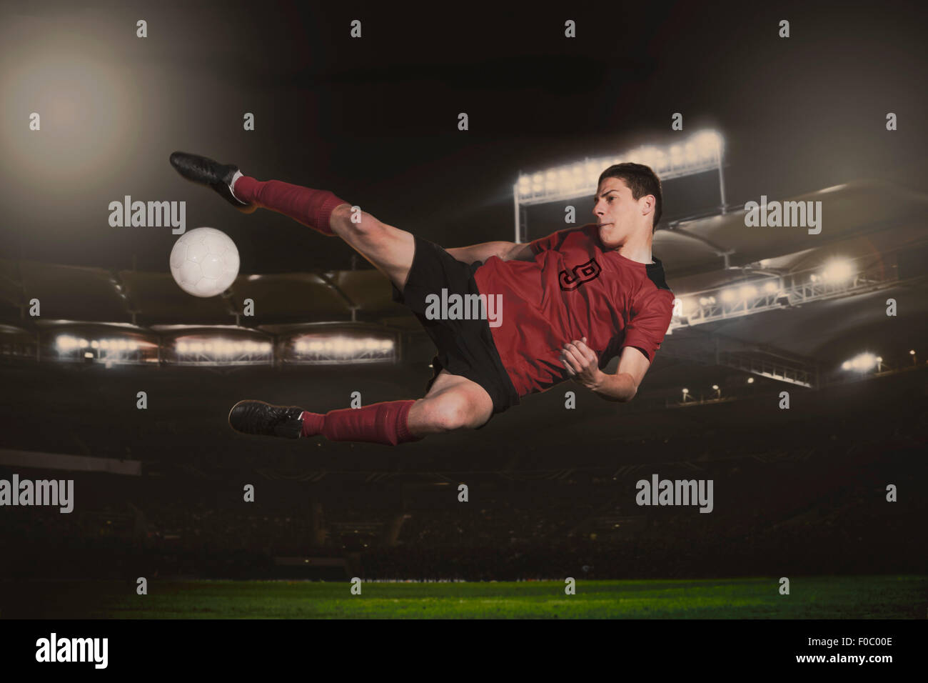 Lunghezza completa di giocatore di calcio calci palla durante il match Foto Stock Lunghezza completa di giocatore di calcio calci palla durante il match Foto Stock