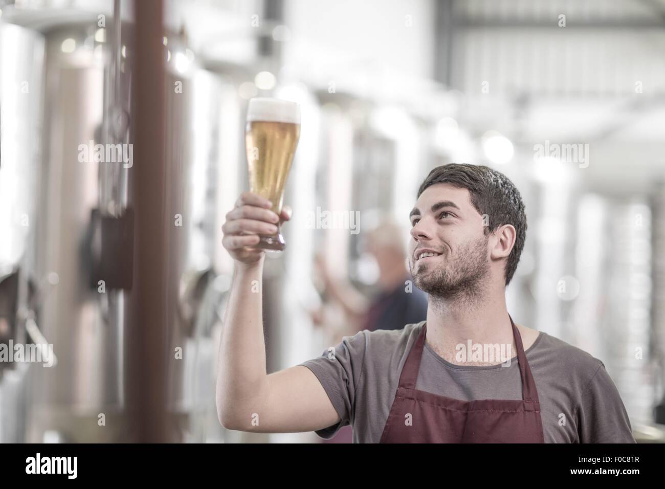 Fabbricante di birra birreria tenendo in mano un bicchiere di birra Foto Stock