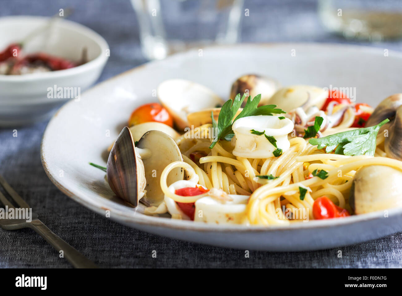 Spaghetti con calamari, vongole e gamberi al sale marino Foto Stock