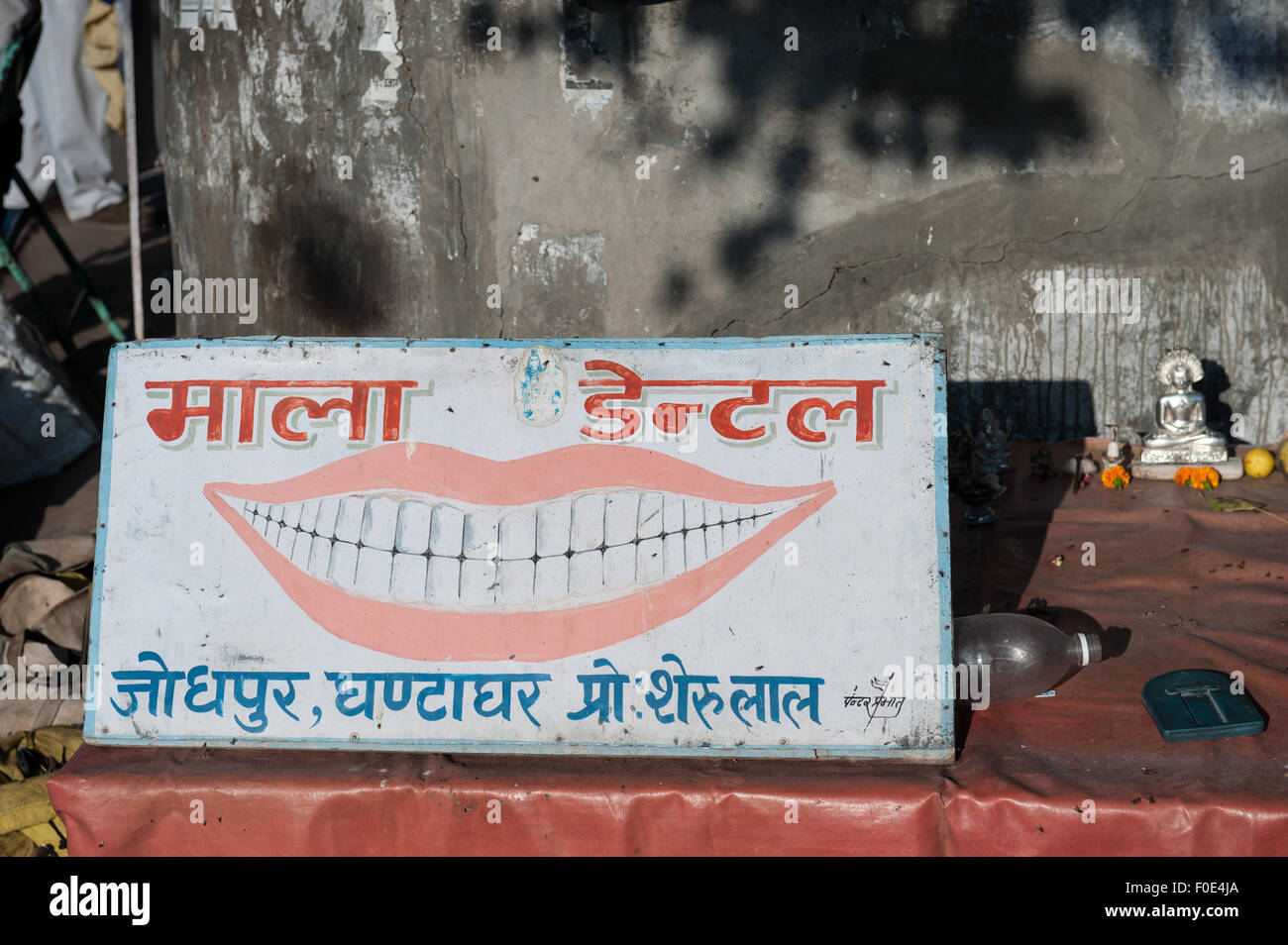 Jodhpur, India. Dentista itineranti il segno sul mercato con la figura del dio Shiva. Foto Stock