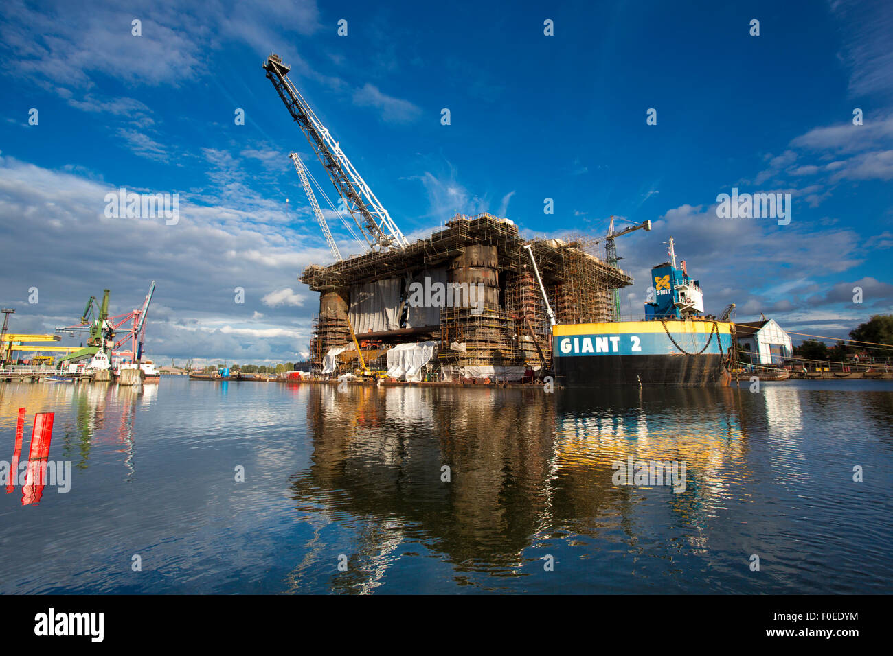 Docking oil rig presso il Cantiere di Danzica in costruzione con un cielo blu chiaro in background. Foto Stock
