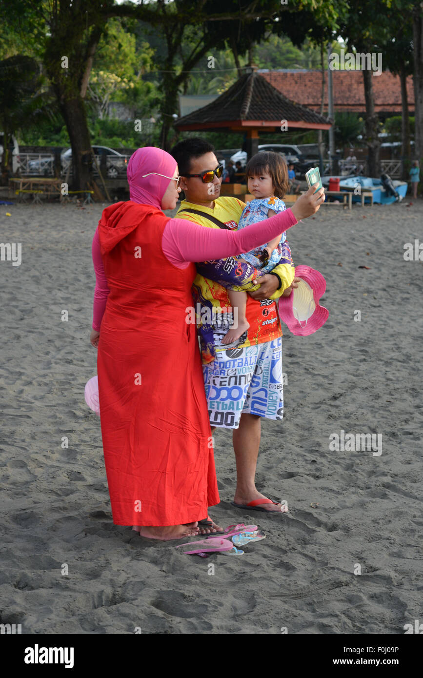 La gente del posto i turisti prendere un selfie a Batukaras nel West Java, Indonesia il 10 agosto 2015. Foto Stock