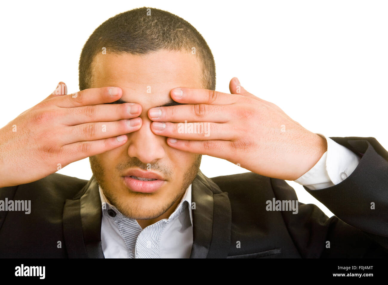 Business uomo chiudendo gli occhi con le mani Foto Stock