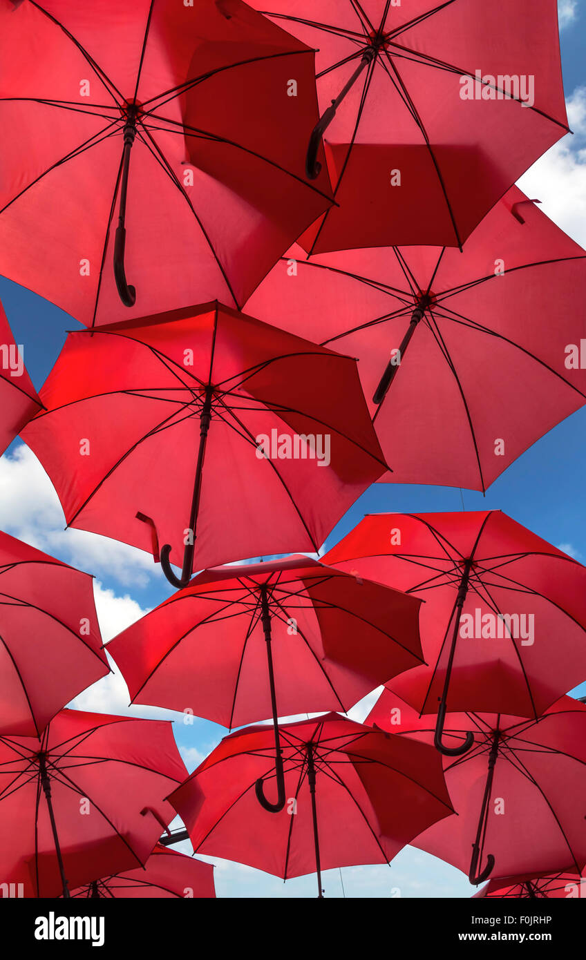 Un sacco di ombrellone rosso street decorazione con cielo blu in background. Foto Stock
