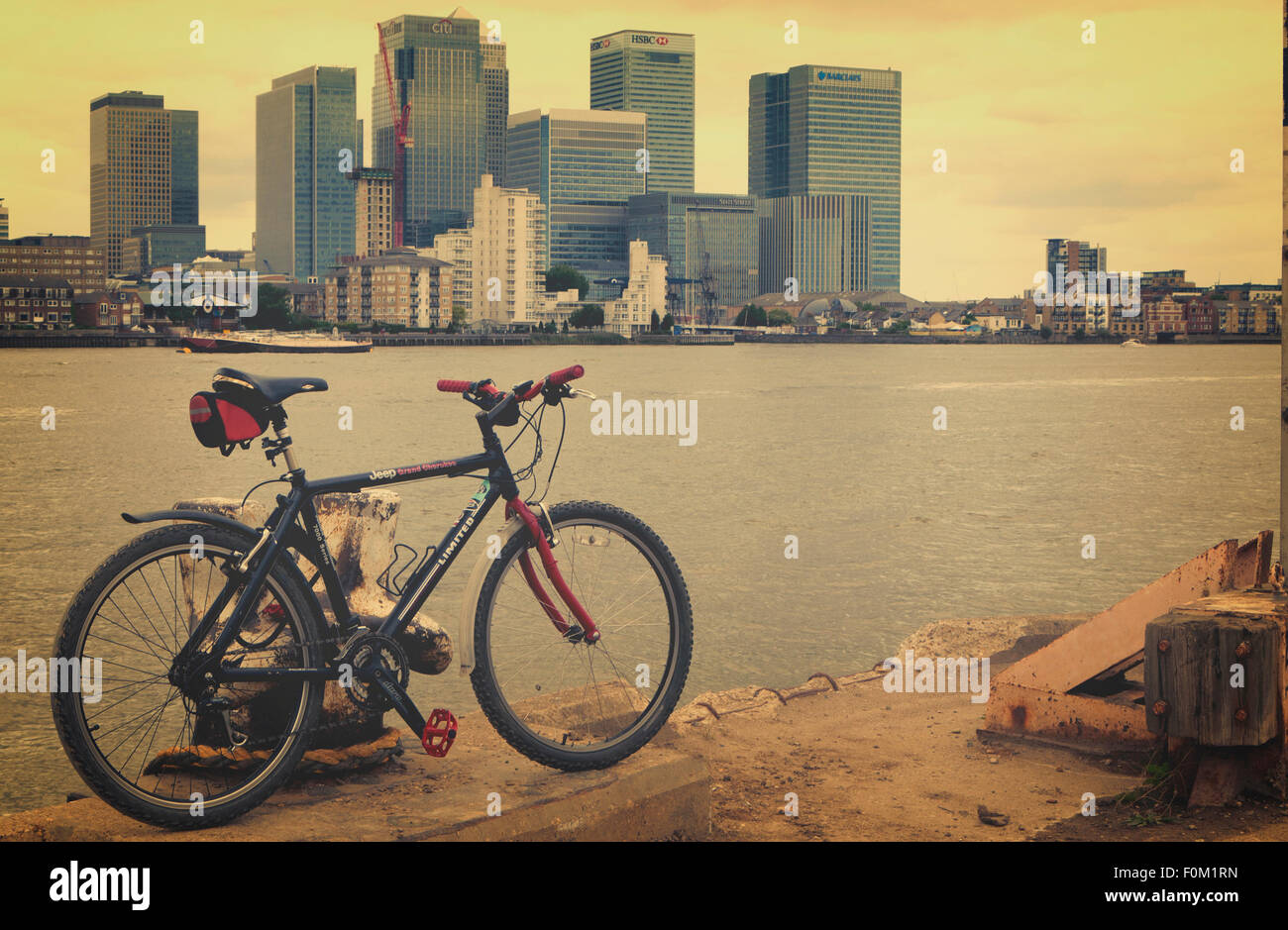 Bicicletta di montagna dal fiume Tamigi si affaccia su Canary Wharf London REGNO UNITO Foto Stock