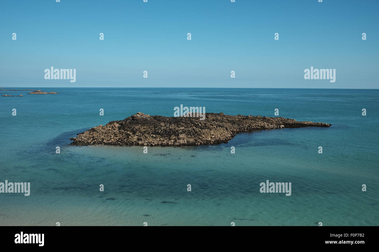 Una vista da Herm isola guardando fuori in mare per un isola di roccia si trova a poca distanza dalla costa di Guernsey Foto Stock