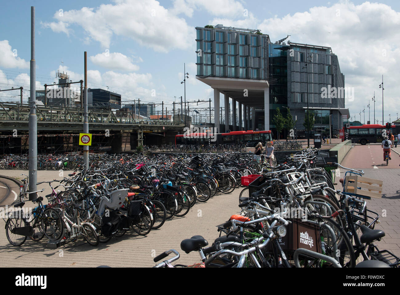 Biciclette a noleggio si erge vicino alla stazione, Amsterdam, Paesi Bassi Foto Stock