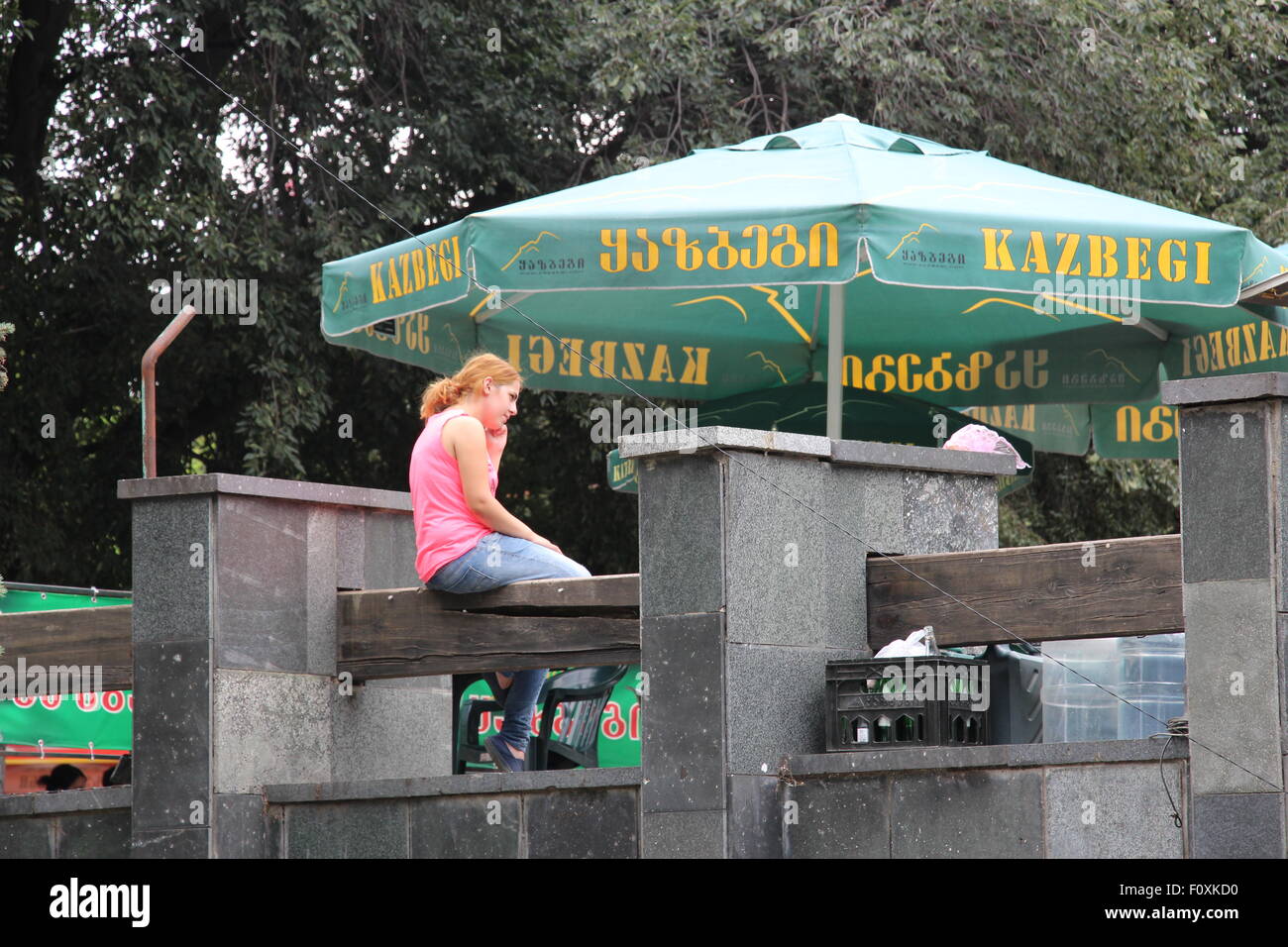 Bar gara seduto sotto Kazbegi ombrellone al bar esterno Foto Stock