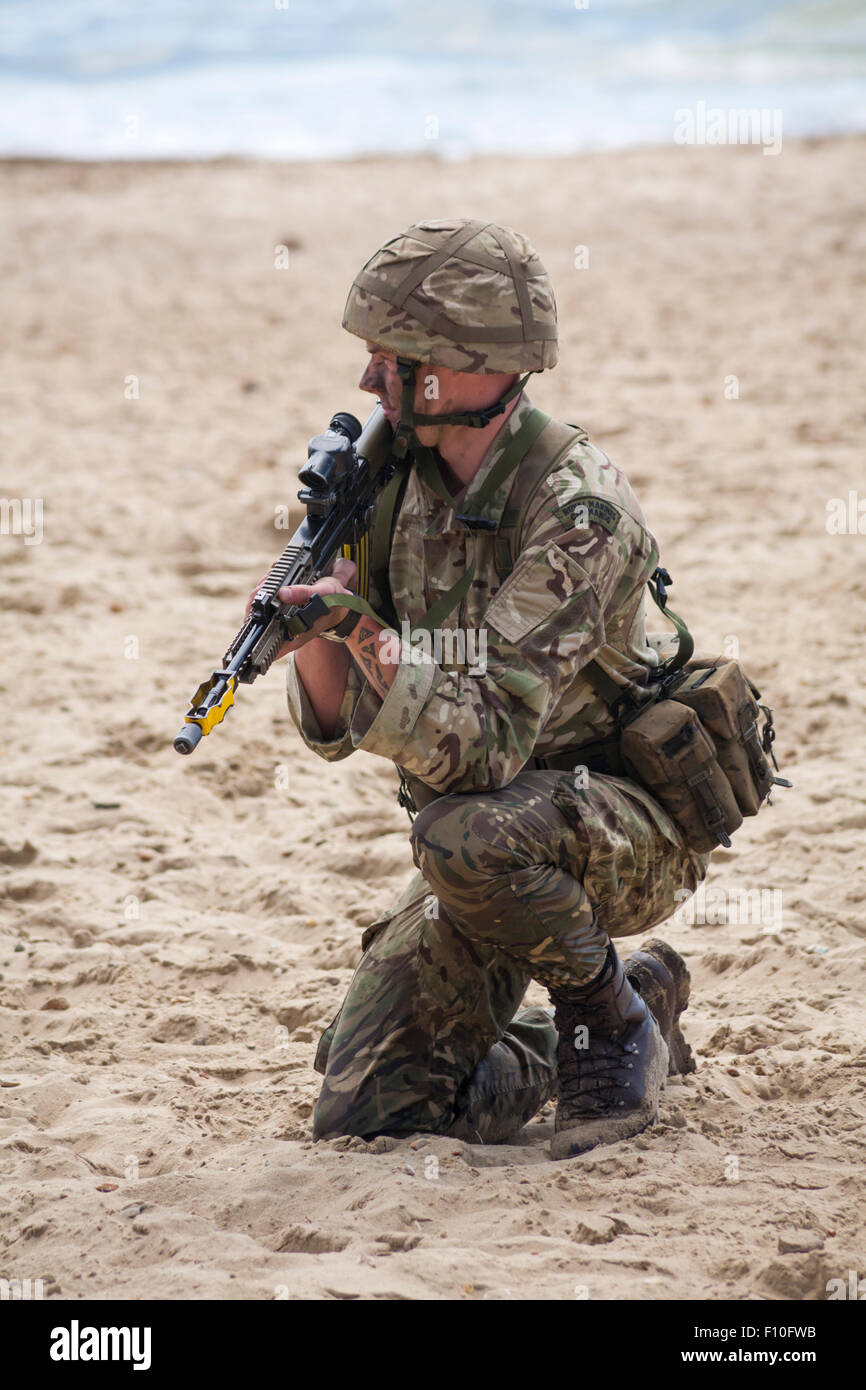 Royal Marines Commando prendendo parte al beach assault a Bournemouth Air Festival nel mese di agosto Foto Stock