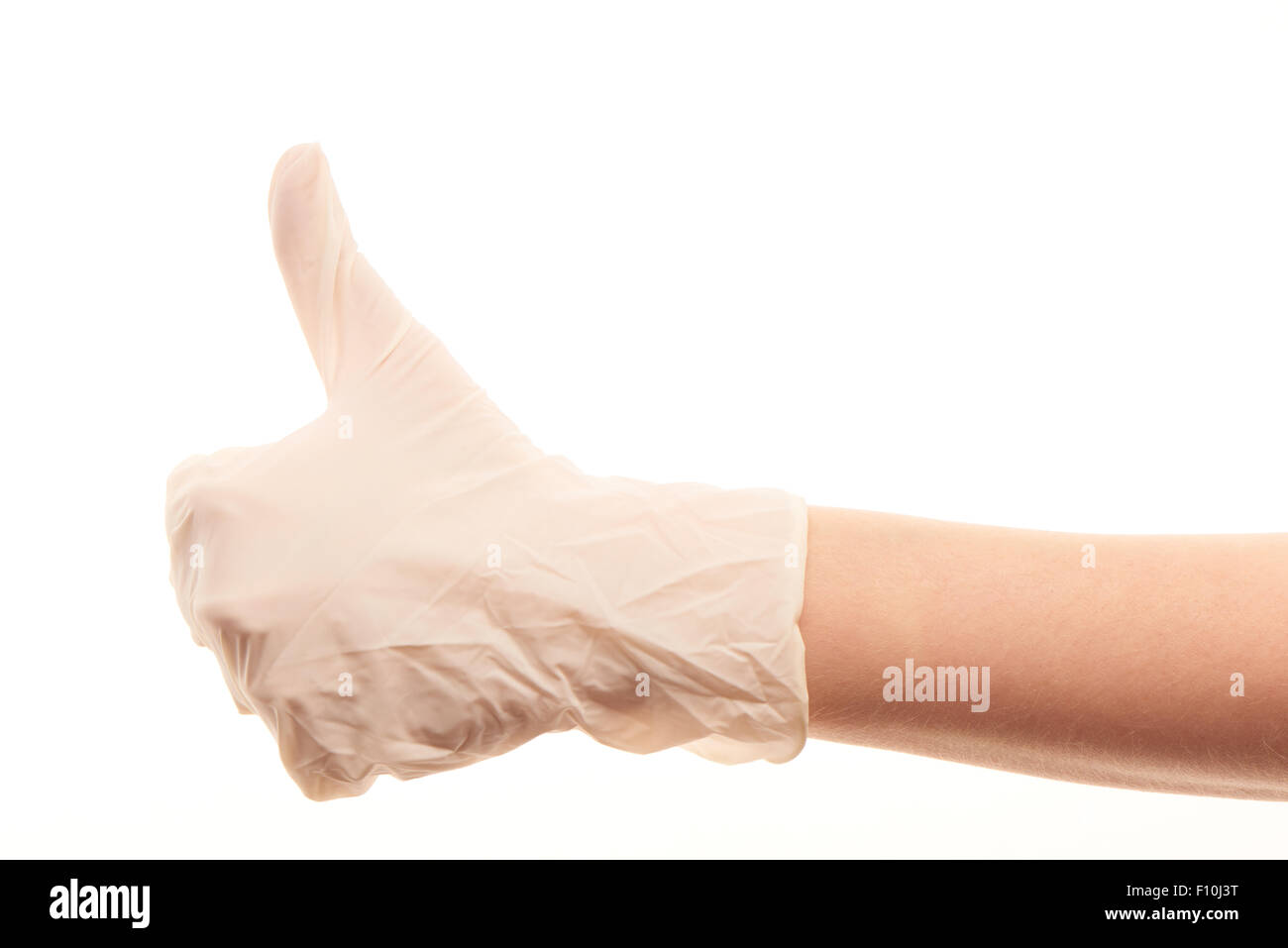 Close up medico donna la mano in bianco sterilizzato guanto chirurgico mostra pollice in alto segno contro uno sfondo bianco Foto Stock