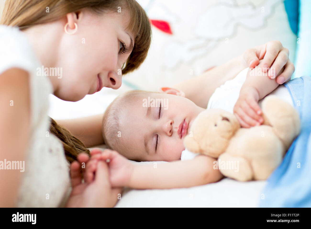 Felice madre cuddling suo neonato Foto Stock