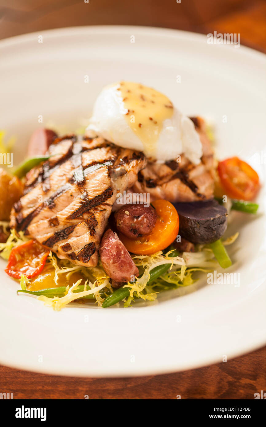 Grigliata di salmone king con insalata frisee, pancetta, soft Uovo affogato e vinaigrette di senape, Bella Vista Ristorante Foto Stock