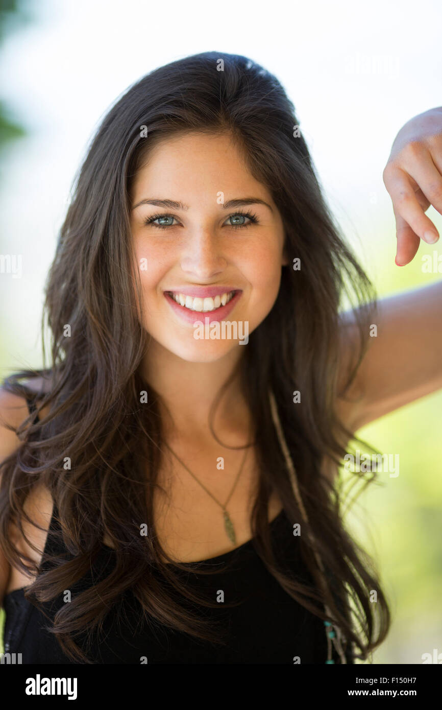 Donna felice con lunghi capelli castani e gli occhi blu Foto Stock