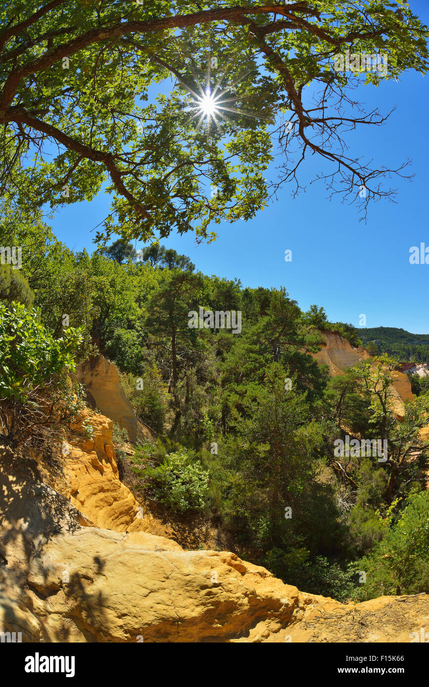 Rottura ocra con Sun in estate, Colorado provenzale, Rustrel, Provenza, Vaucluse Francia Foto Stock