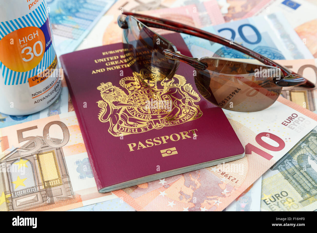 Articoli da viaggio con British passaporto biometrico valuta Euro crema solare e occhiali da sole per viaggiare in paesi di Eurozona dal Regno Unito per una vacanza estiva Foto Stock