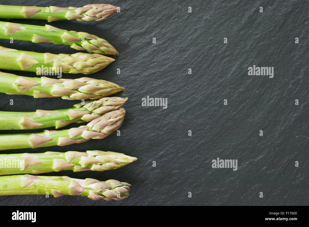 Freschi asparagi verdi dal mercato su un nero ardesia platter Foto Stock