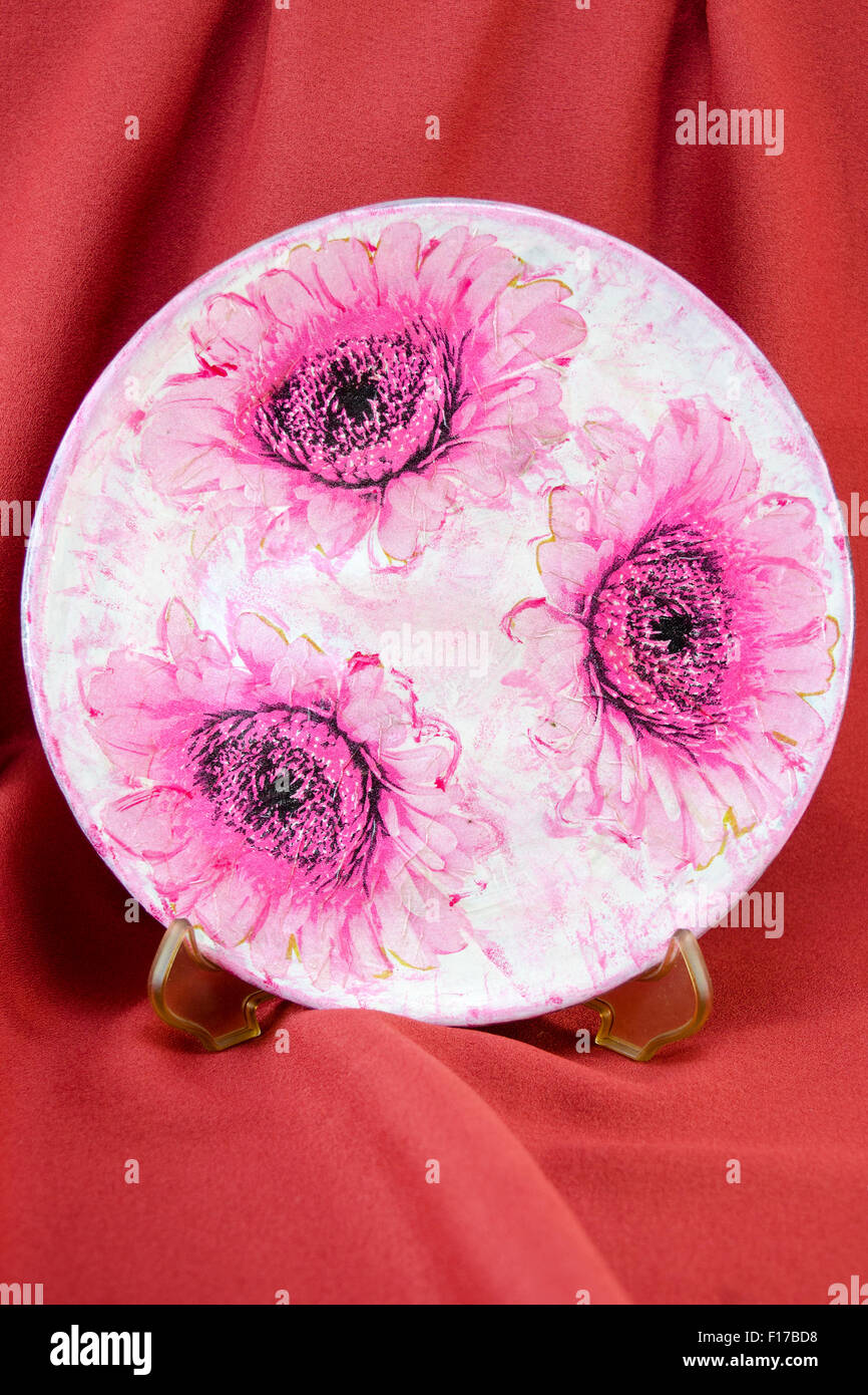 Decorate Decoupage flower placca modello sulla stoffa rossa sullo sfondo. Decoupage tehnique Foto Stock
