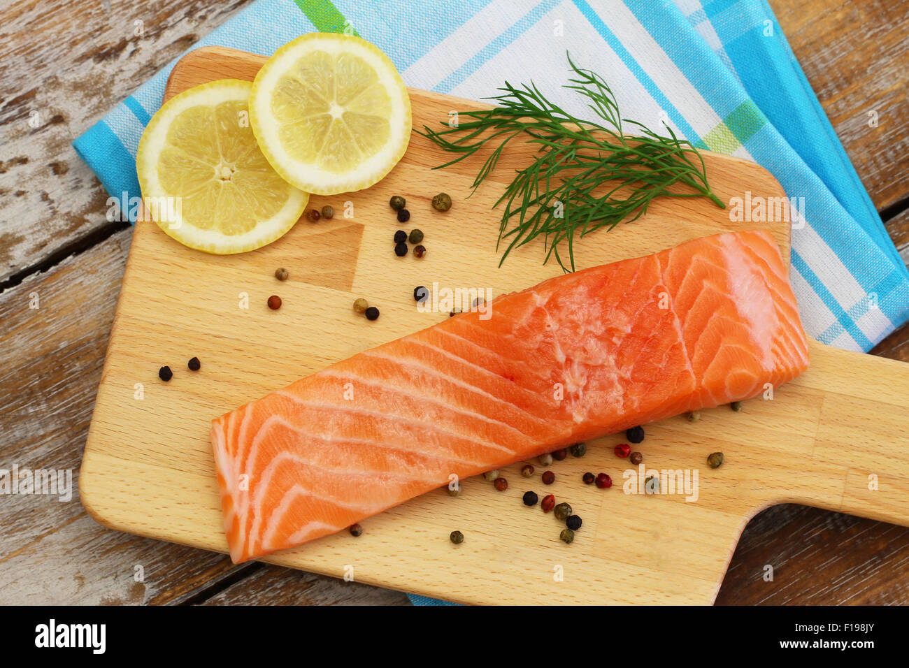 Materie filetto di salmone su pannello di legno Foto Stock