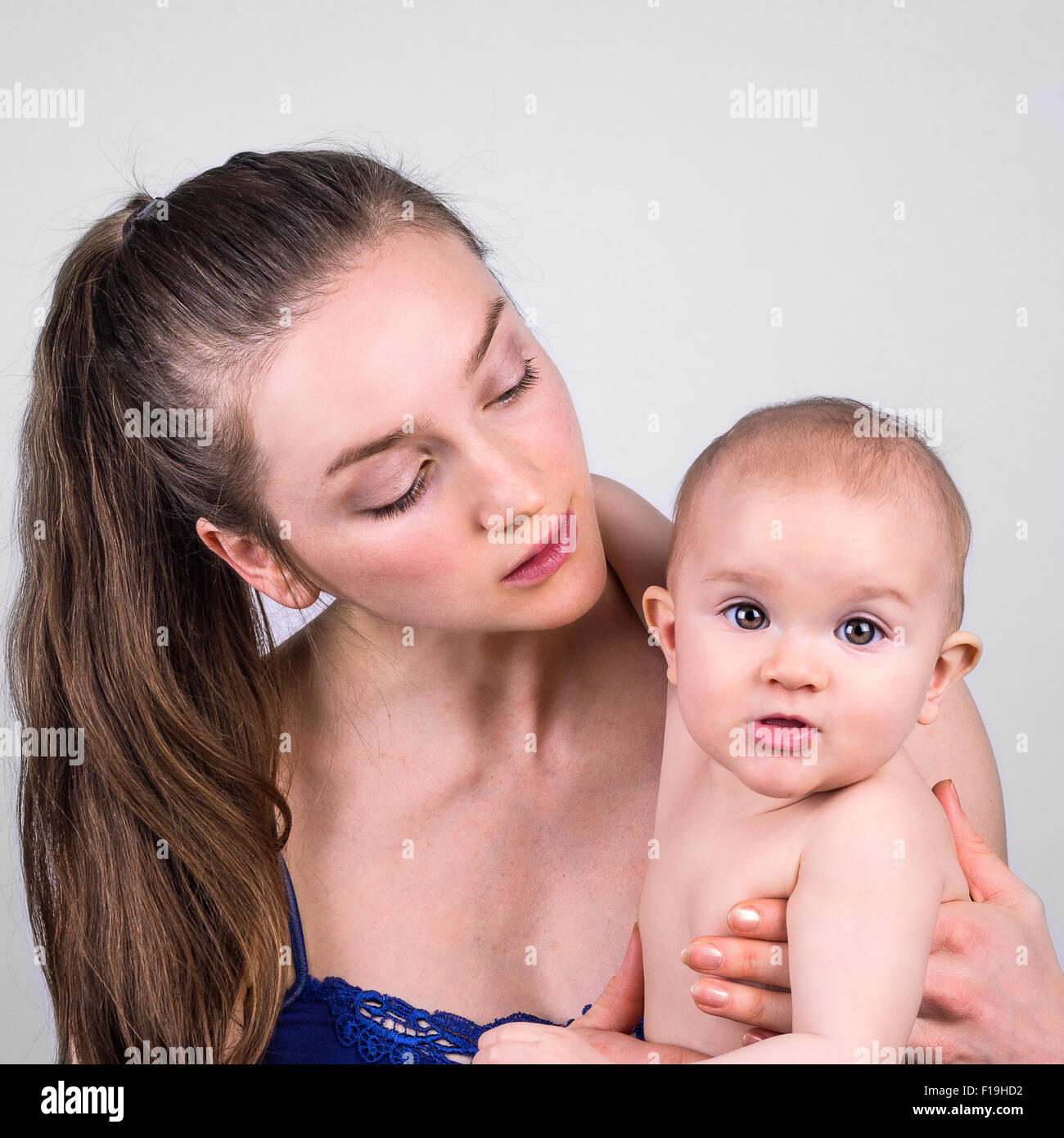 Carino il bambino e la madre ritratto su sfondo bianco Foto Stock