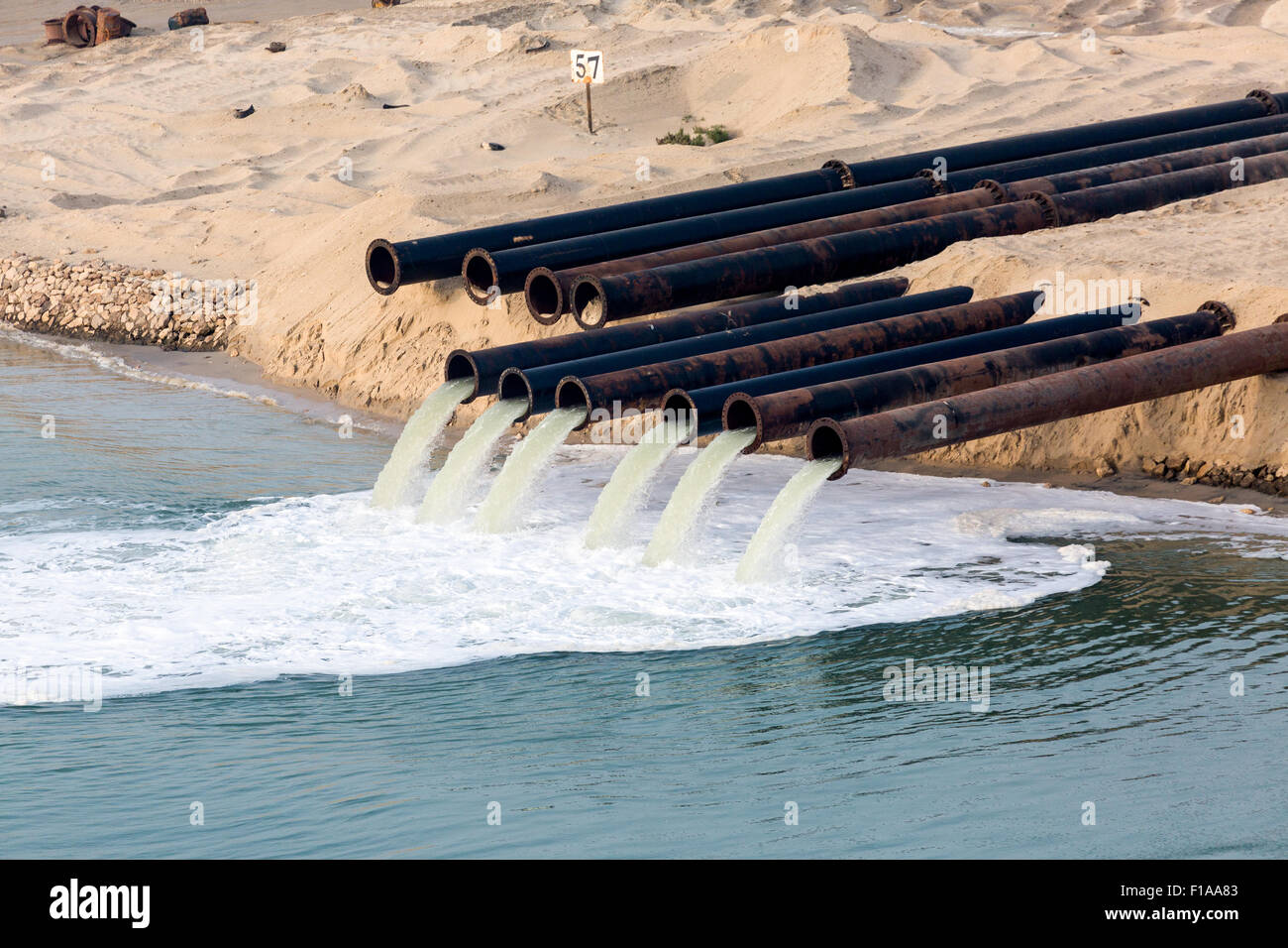 Tubi di uscita per il pompaggio di acqua nel canale di Suez dal deserto la costruzione di una nuova sezione del canale di Suez in Egitto. Foto Stock