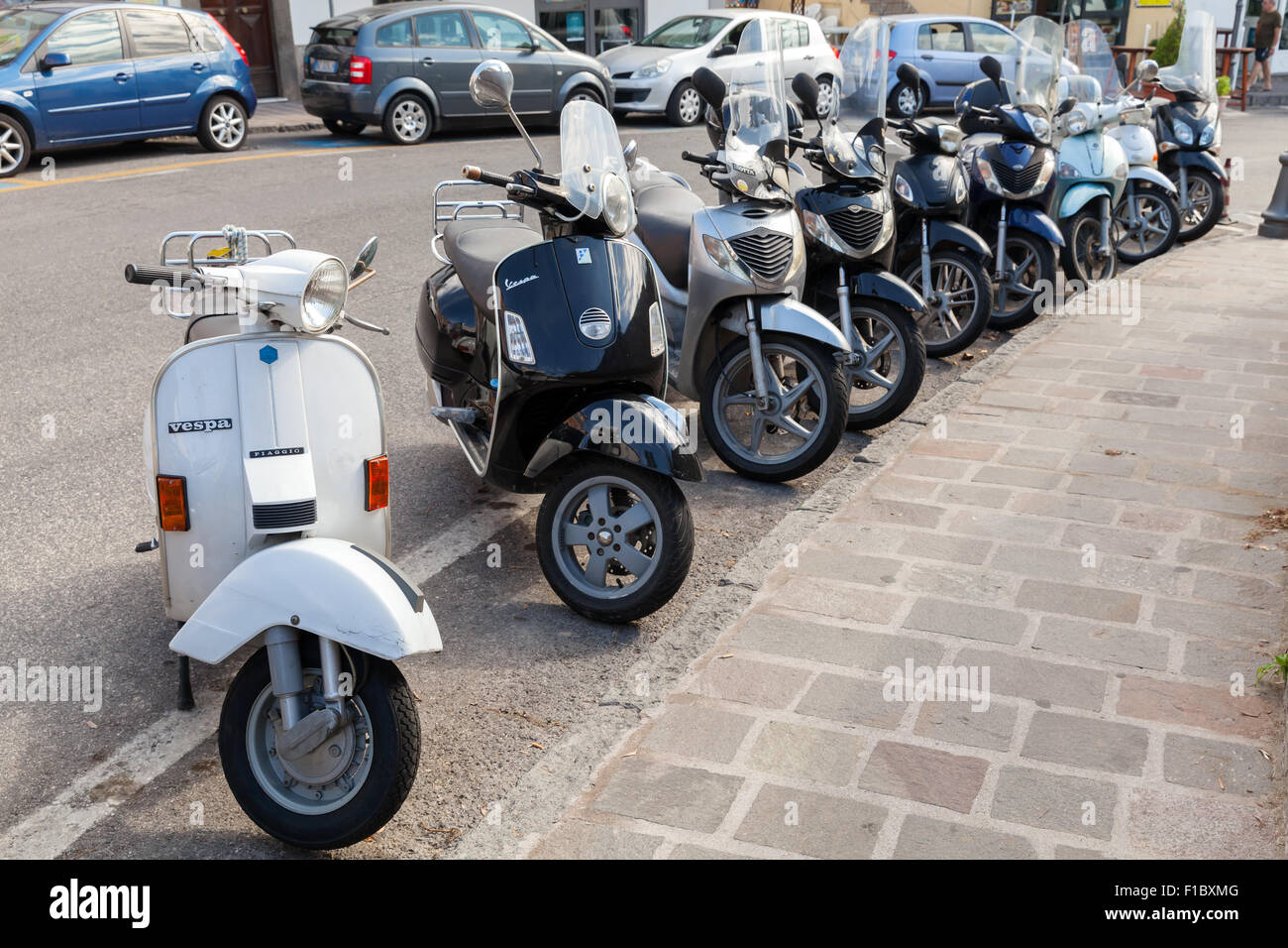 Lacco Ameno, Italia - 15 agosto 2015: Classic Vespa e scooter Honda sta parcheggiato su una strada, l'isola d' Ischia Foto Stock