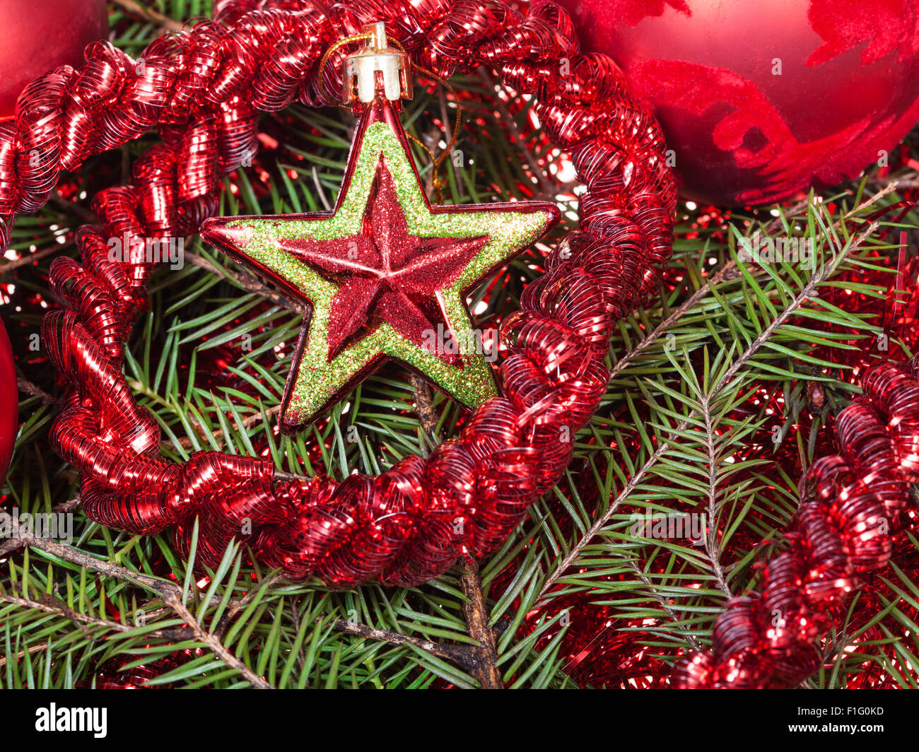 Natale ancora in vita - stella rossa, baubles di Natale, tinsel su albero di Natale sfondo Foto Stock