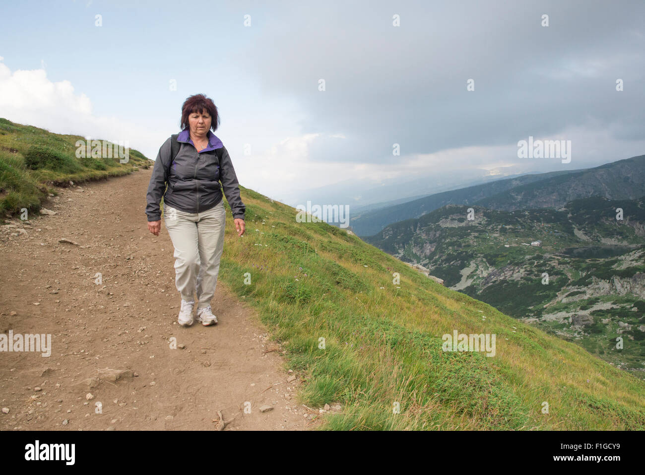 Senior donna passeggiate in montagna. Foto Stock