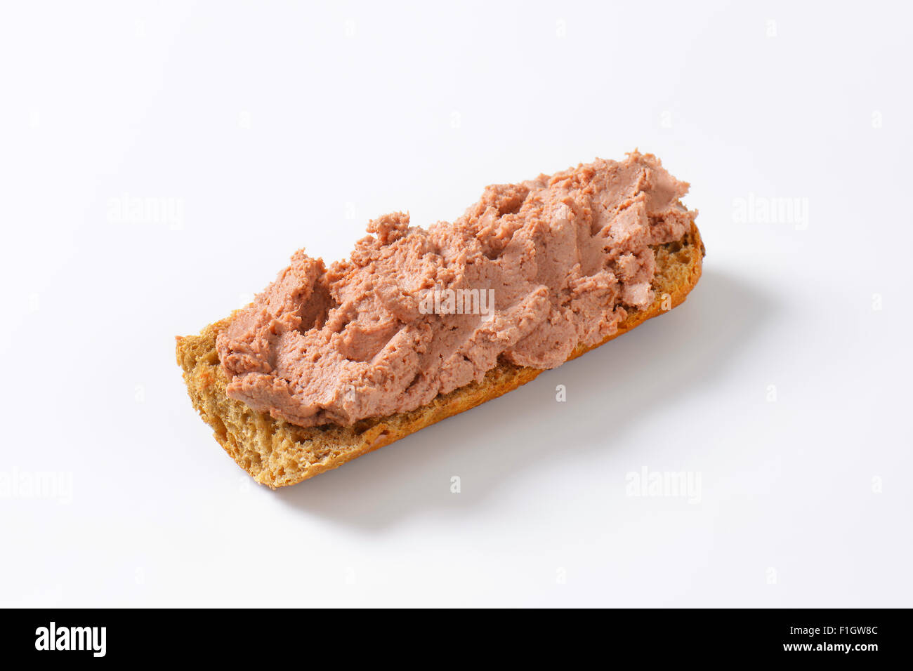 Baguette fresca con paté su sfondo bianco Foto Stock