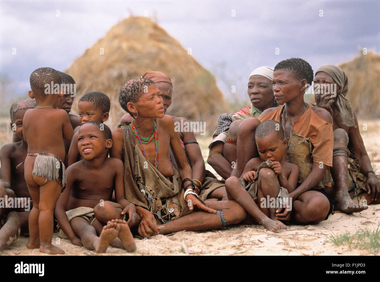 Bush persone seduti all'aperto, Namibia, Africa Foto Stock