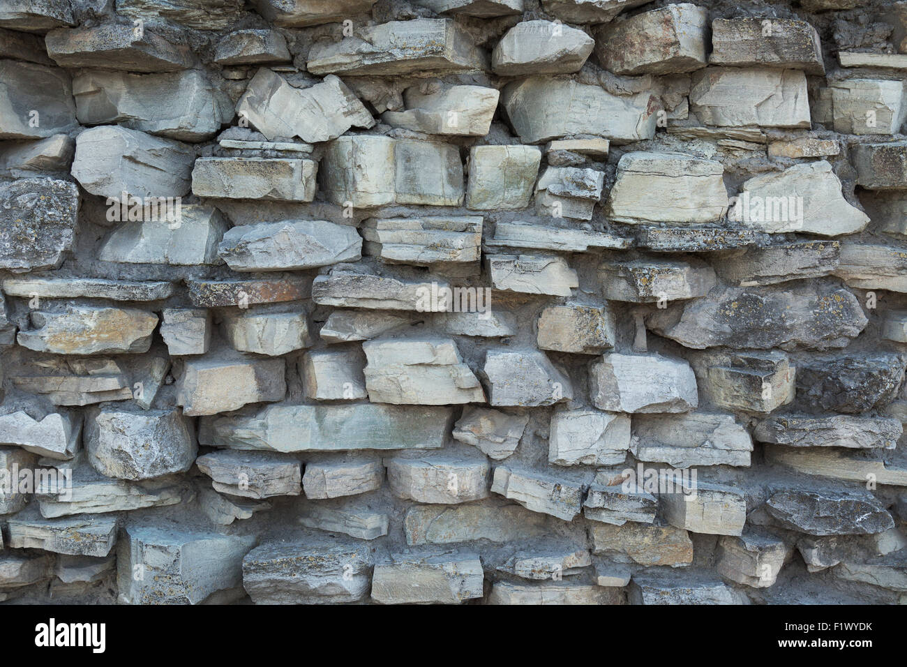 Il vecchio muro di pietra come uno sfondo. Foto Stock