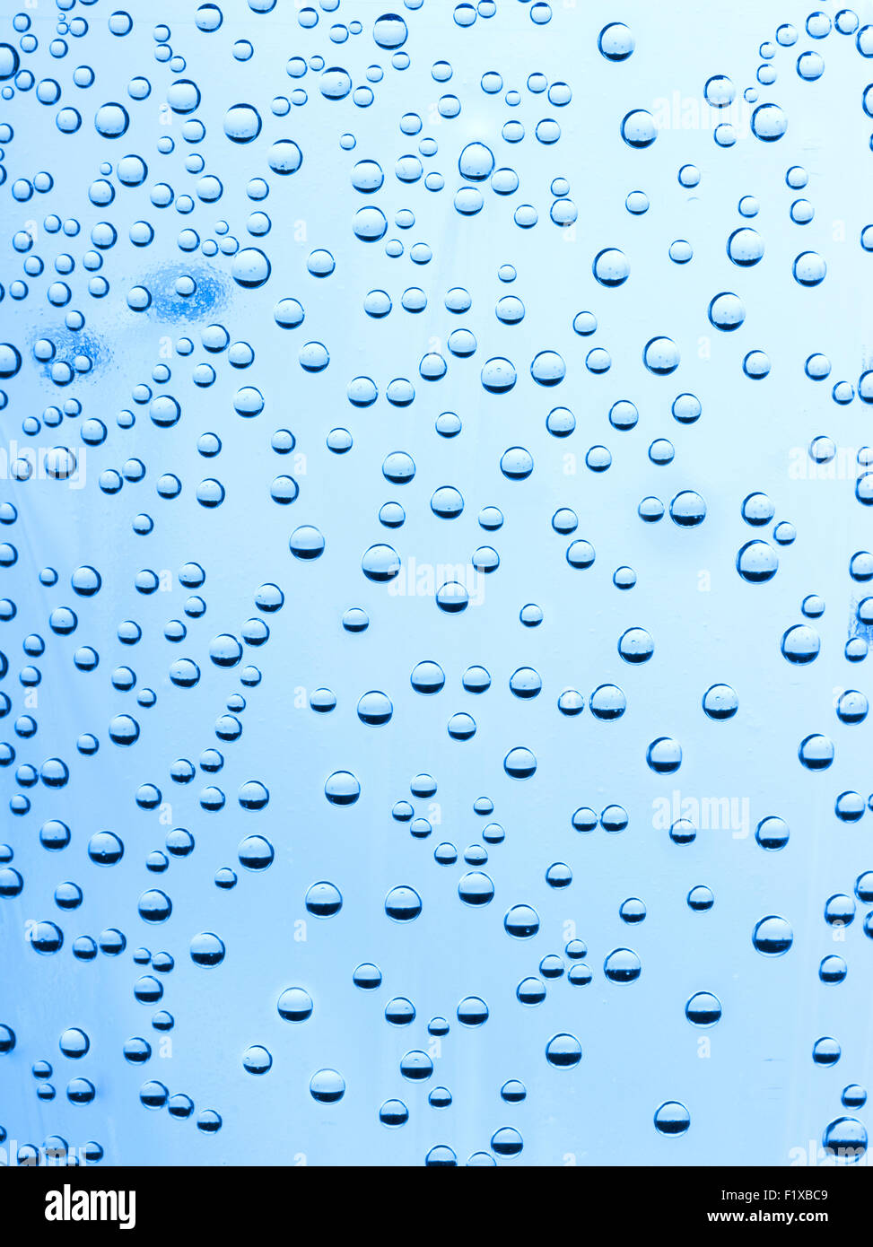 Gocce di acqua su uno sfondo blu. Foto Stock