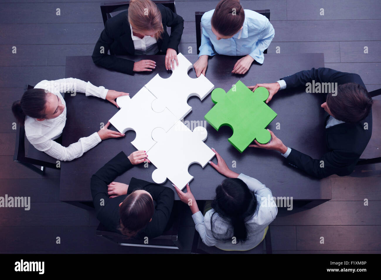 Team aziende risolvendo puzzle Foto Stock