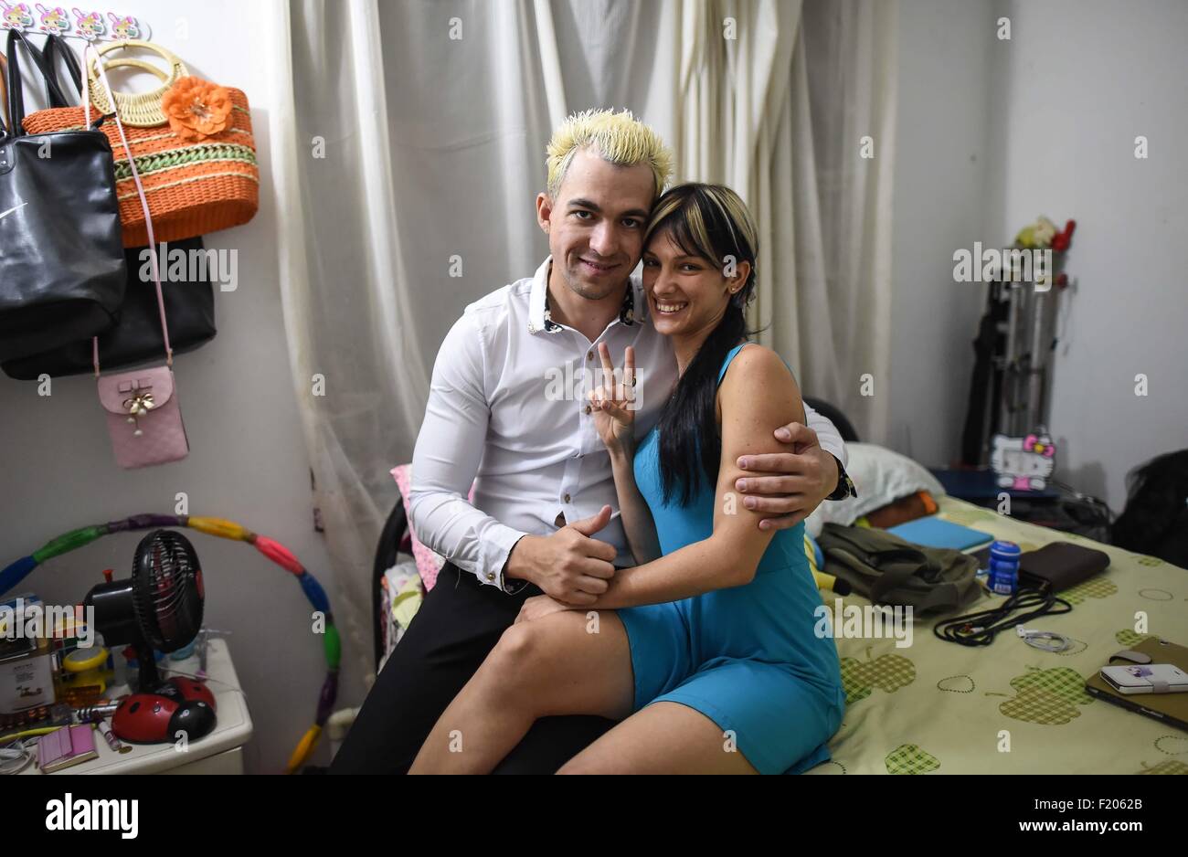 (150909) -- CHANGCHUN, Settembre 9, 2015 (Xinhua) -- Cubanese giovane Inalbis Perez (R) e Juan Madarro di Simon Band posa per foto nel loro piccolo appartamento in Changchun, capitale della Cina del nord della provincia di Jilin, Settembre 8, 2015. In Changchun, una banda musicale di nome Simone è unico in confronto con altre bande. Simon si compone di cinque membri, Inalbis Perez e suo marito tamburo giocatore Juan Madarro da Cuba, piombo cantanti Nina Glushchenko dal Kirghizistan, Yadria Gonzalez da Cuba e sassofonista Omelchuk Ievgen dall'Ucraina. Esse sono state giocando in Cina per pochi anni. Opera case, parchi, resta Foto Stock