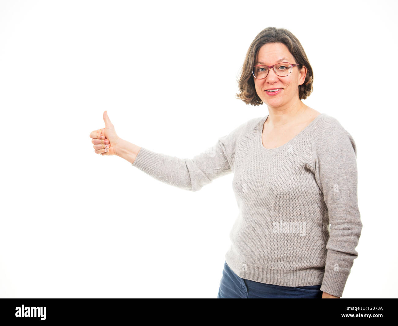 Frau hält Daumen hoch Foto Stock