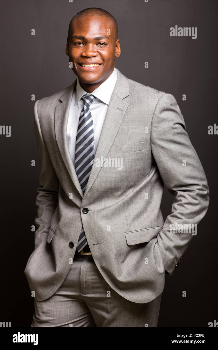 Buona ricerca Afro American businessman in posa su sfondo nero Foto Stock