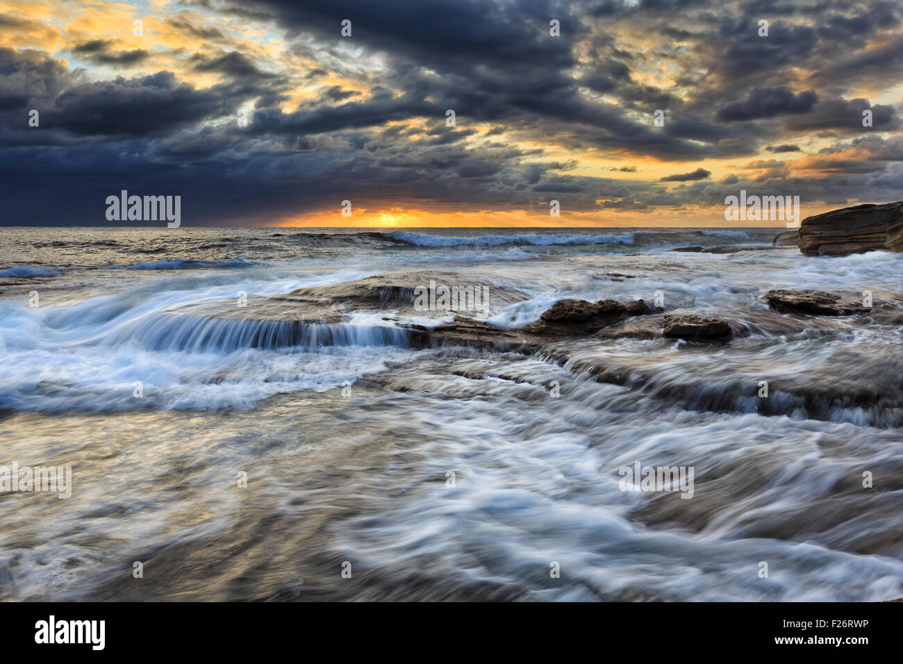 Forti onde costiere sulle rocce di arenaria vicino a Maroubra spiaggia della costa del Pacifico a Sydney a sunrise Foto Stock