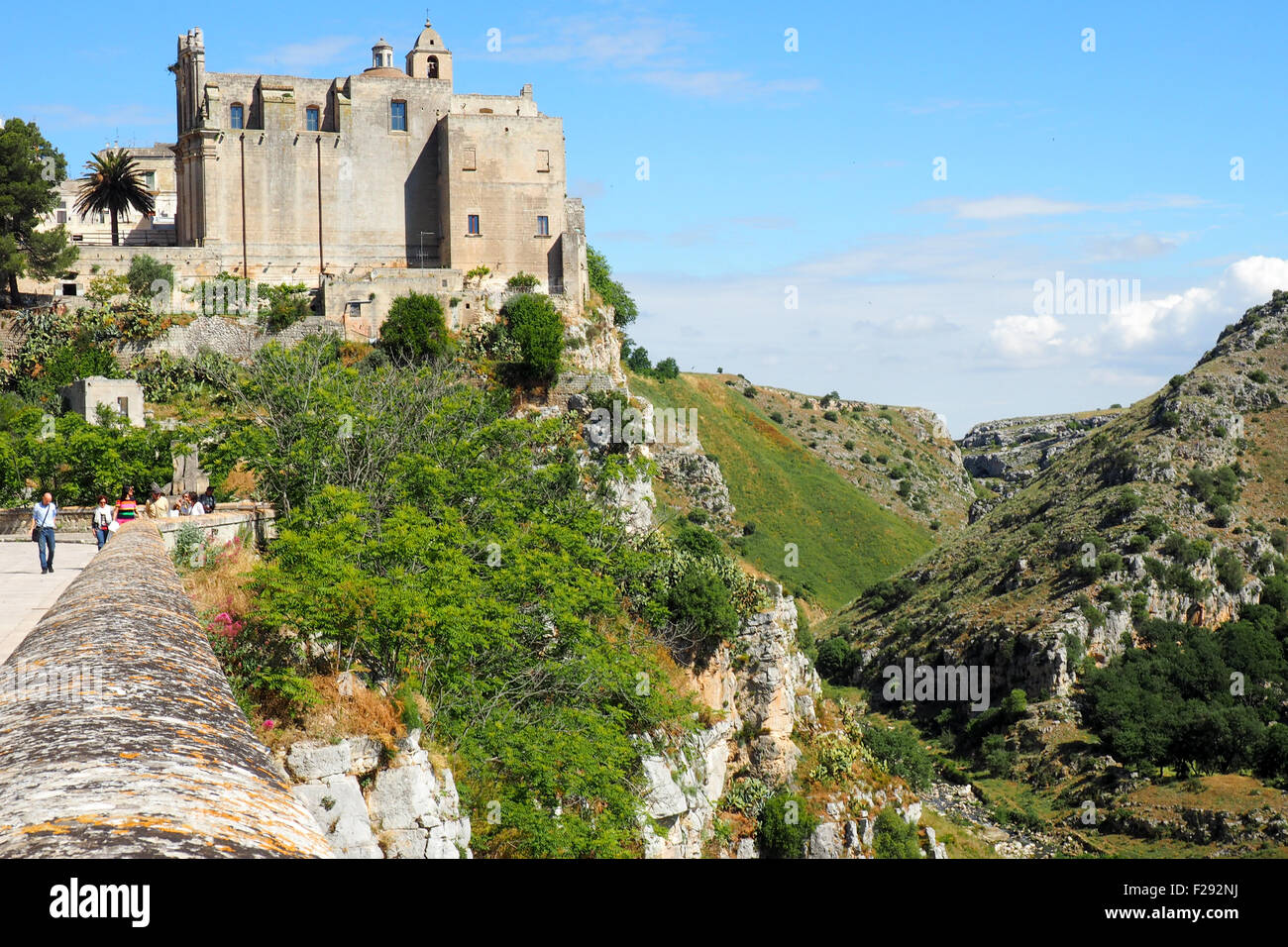 Abitazioni troglodite in una scogliera e vista laterale del convento di San Agostino dal Sasso Barisano Matera. Foto Stock