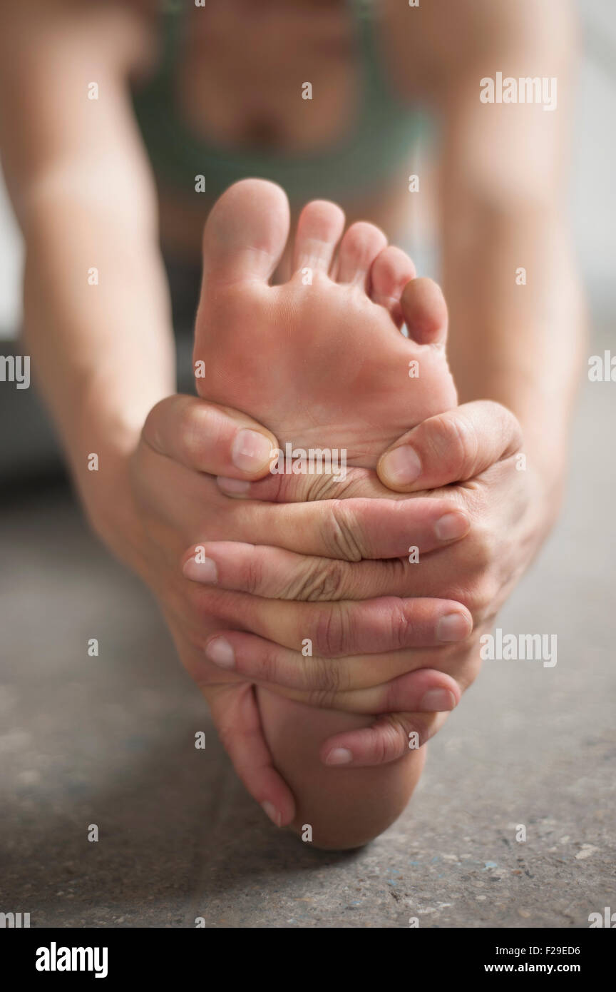 Donna pratica janu sirsasana pongono in studio di yoga, Monaco di Baviera, Germania Foto Stock