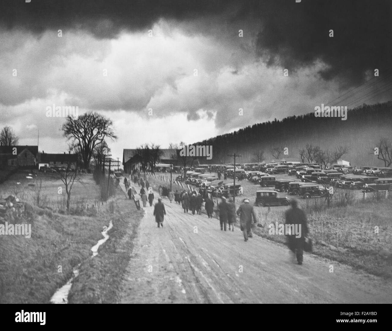 L ex Presidente Calvin Coolidge messo a riposare in Plymouth, Vermont. Gen 7, 1933. Pesanti nuvole scure passando il mouse sopra la strada a Plymouth, Vermont, come cittadini piedi verso la tomba di collina. Un contadino locale fornito uno spazio di parcheggio (CSU 2015 9 792) Foto Stock