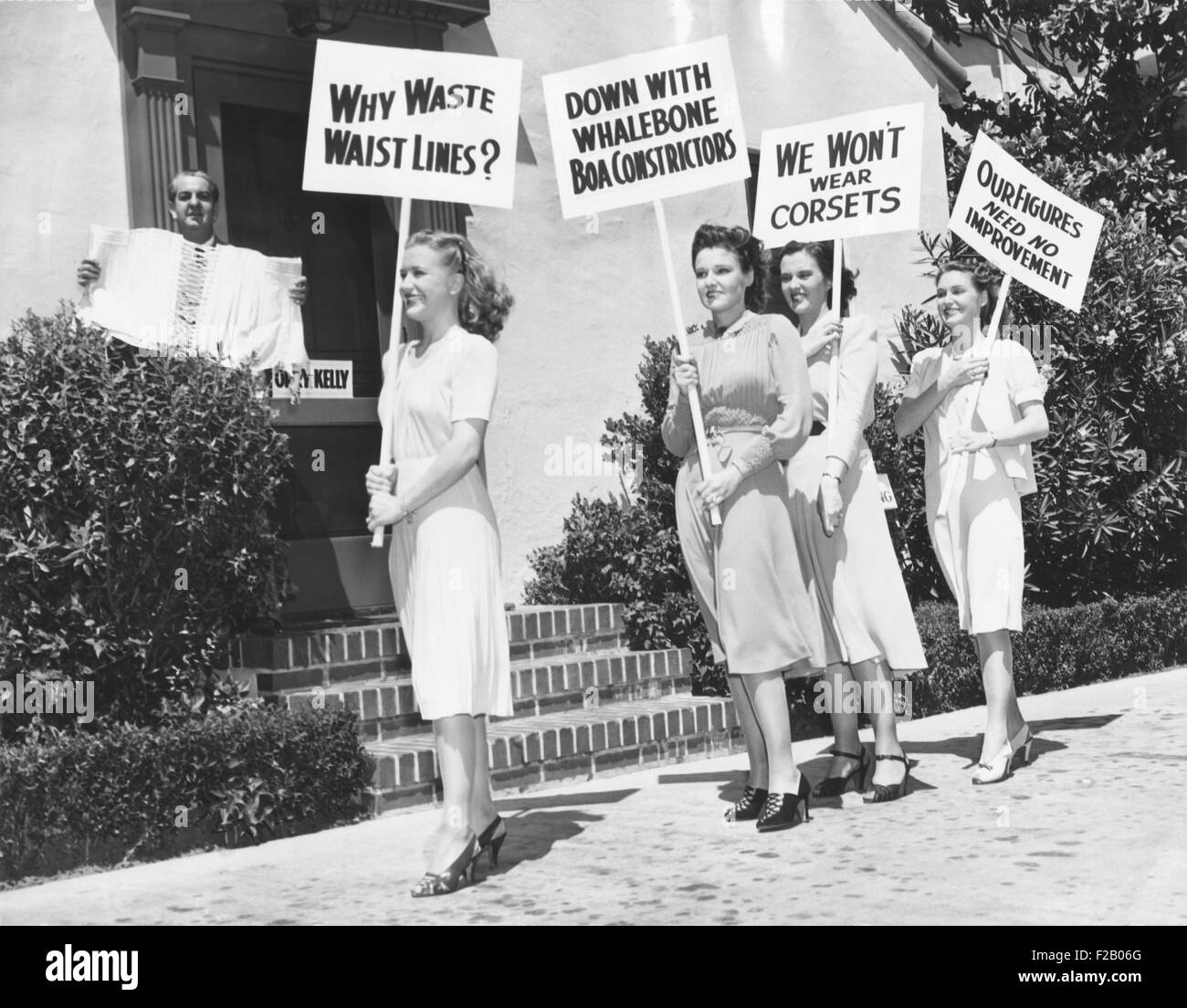 Il Lane sorelle con Gail protesta pagina famosa Hollywood costumista, Orry-Kelly. Agosto 28, 1939. La Warner Brothers, designer piacente Kelly detiene un corsetto, le attrici picket con segni di lettura: Noi non indossare corsetti, giù con un Whalebone Boa Constrictor e i nostri dati non necessitano di alcun miglioramento I. (CSU 2015 9 675) Foto Stock