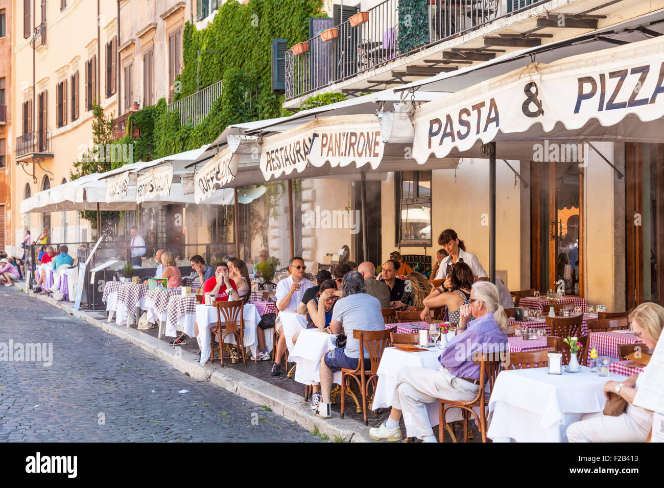 I turisti per guardare la gente e cenare presso il ristorante Panzirone nella Piazza Navona Roma Italia Roma Lazio Italia Europa UE Foto Stock
