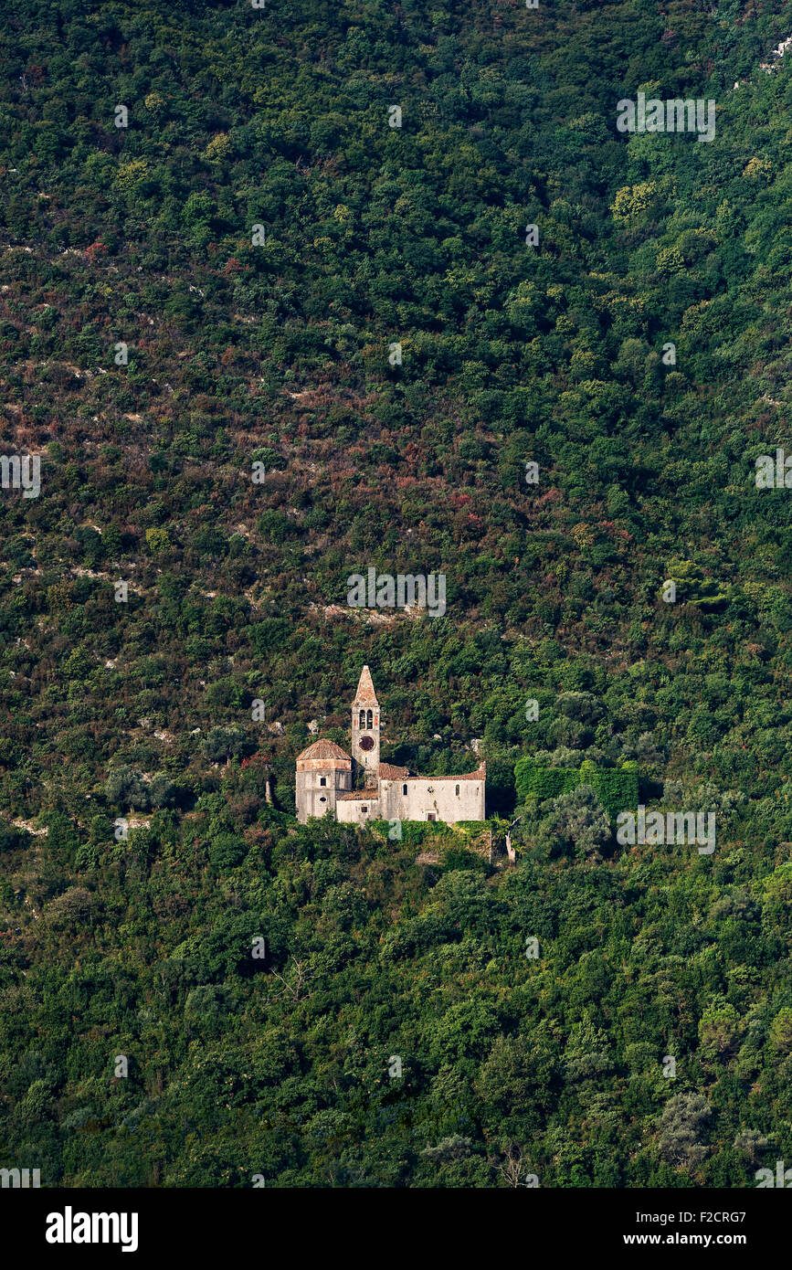 Chiesa rovina che siede sul versante di una montagna sopra il paese di Prcanj, Montenegro Foto Stock